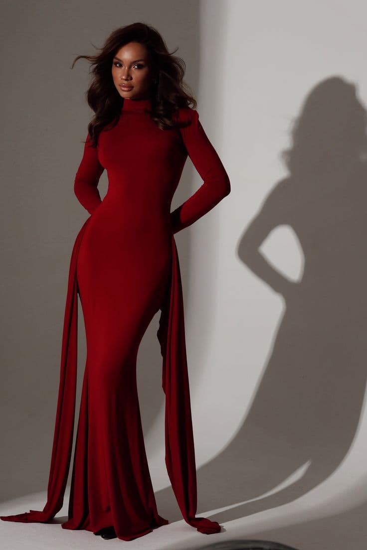 Deep red gown with a high neck and long draped sleeves